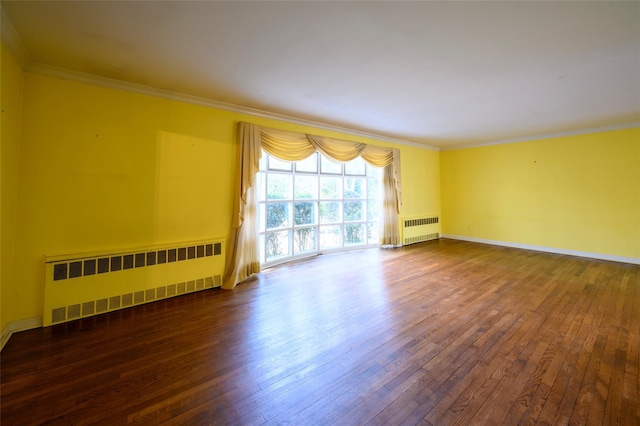 unfurnished room featuring radiator heating unit, wood-type flooring, and crown molding