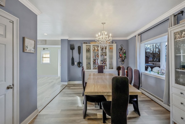 dining space with wood finished floors, baseboards, an inviting chandelier, ornamental molding, and baseboard heating