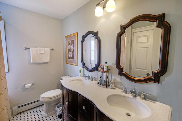 bathroom featuring double vanity, toilet, a baseboard heating unit, and a sink