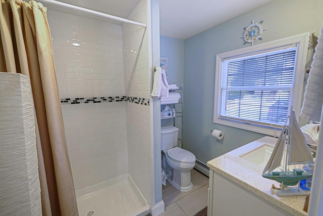 full bathroom with vanity, toilet, a stall shower, and a baseboard radiator