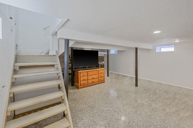 below grade area featuring recessed lighting, stairway, and baseboards