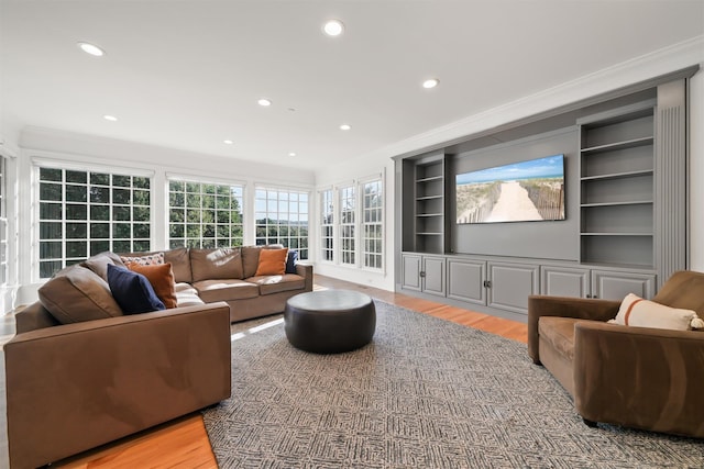 living area featuring recessed lighting, built in shelves, wood finished floors, and ornamental molding