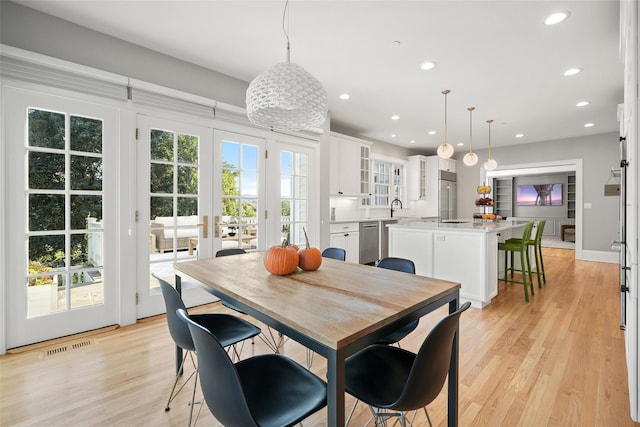 dining area with visible vents, recessed lighting, light wood-type flooring, and french doors