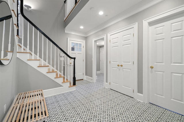 entryway with recessed lighting, stairway, baseboards, and crown molding