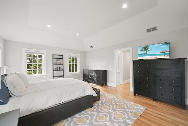 bedroom with visible vents, baseboards, lofted ceiling, light wood-style flooring, and recessed lighting