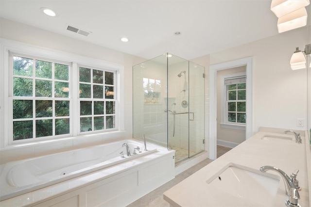 full bathroom featuring a sink, visible vents, a garden tub, and a shower stall