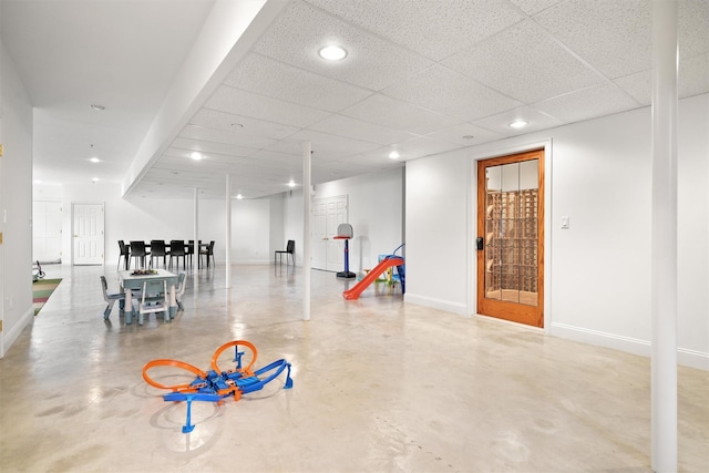 basement with recessed lighting, baseboards, and a paneled ceiling