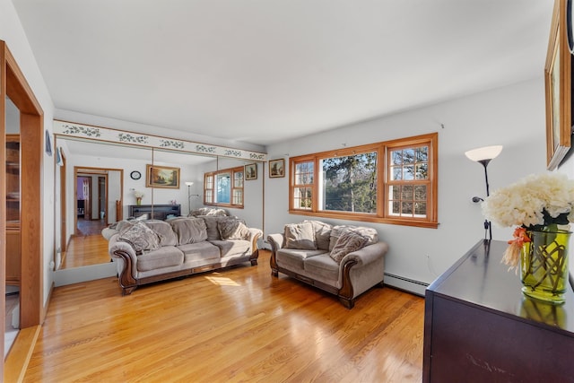 living room featuring baseboard heating and light wood finished floors