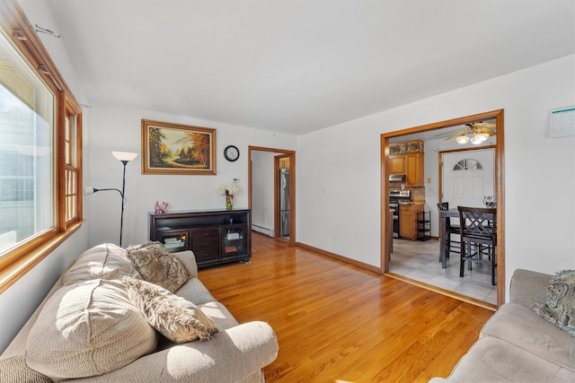 living room with light wood-style flooring and baseboards