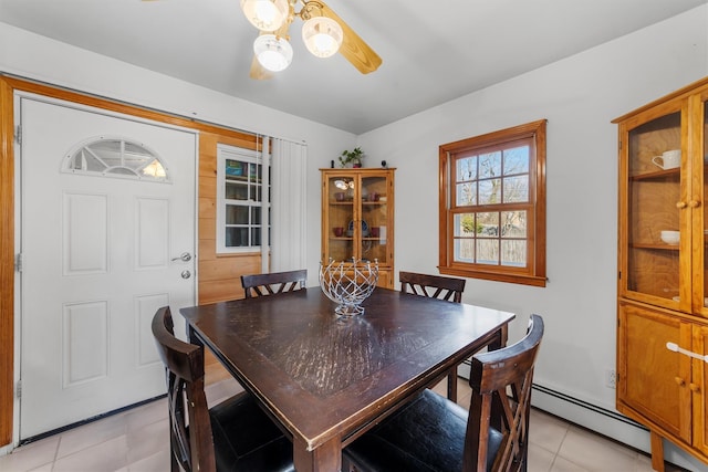 dining area featuring light tile patterned floors and baseboard heating