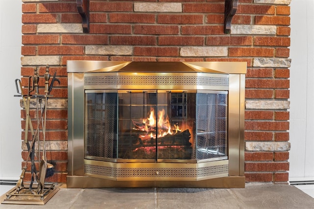 details with a brick fireplace and concrete floors