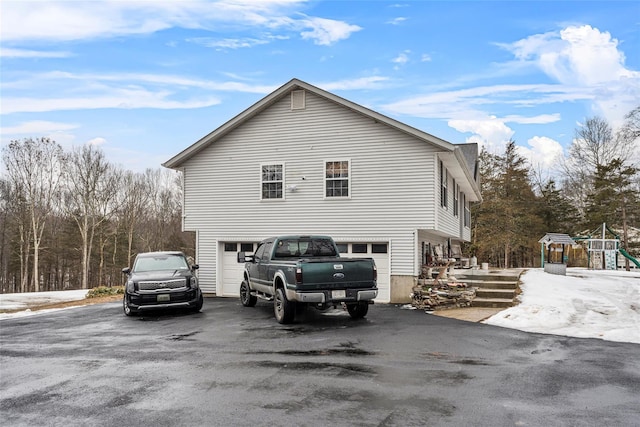 view of home's exterior featuring a garage and driveway