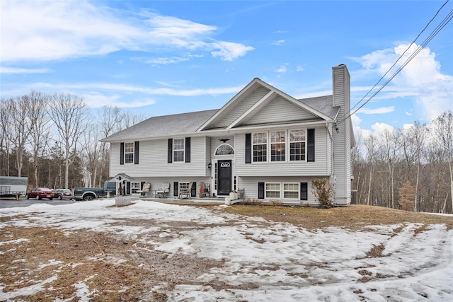 bi-level home featuring a chimney