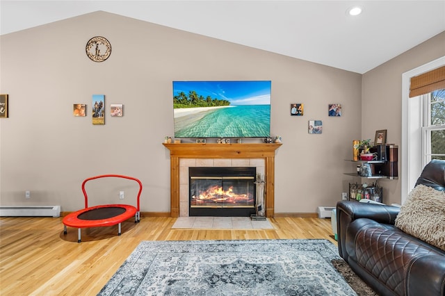 living area with baseboard heating, a fireplace, lofted ceiling, and wood finished floors