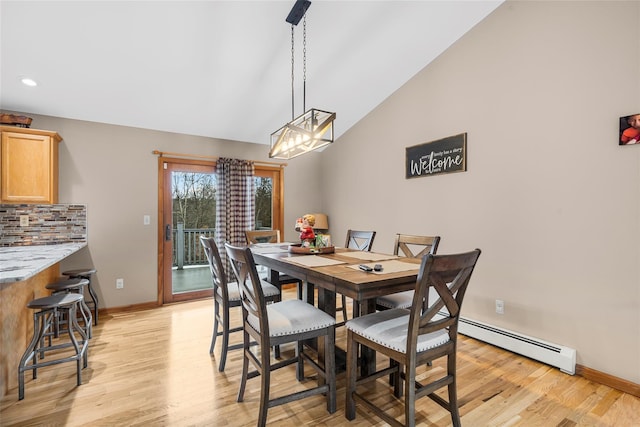 dining room featuring light wood-type flooring, recessed lighting, a baseboard radiator, baseboards, and vaulted ceiling