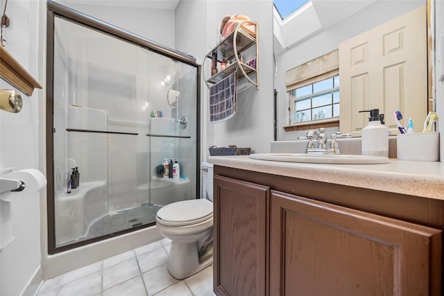 bathroom featuring a stall shower, toilet, a skylight, and tile patterned floors