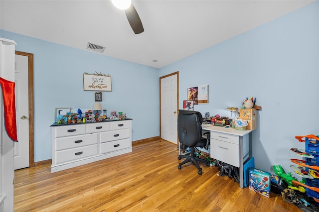 office space featuring visible vents, ceiling fan, baseboards, and light wood-style floors