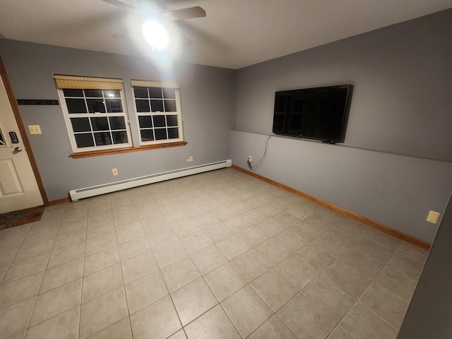 tiled empty room featuring baseboards, a ceiling fan, and a baseboard radiator