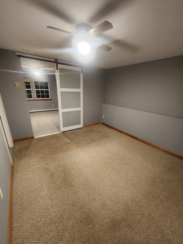 interior space with baseboard heating, ceiling fan, baseboards, and carpet floors