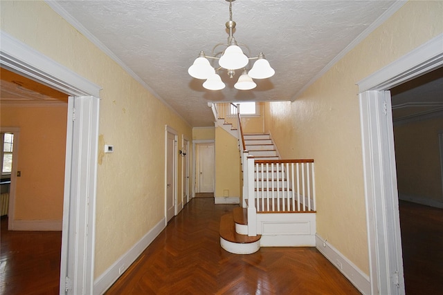 corridor with ornamental molding, a textured ceiling, and a textured wall