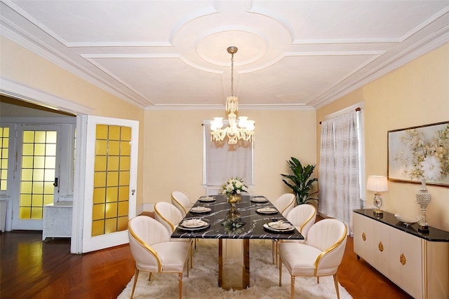 dining space featuring parquet flooring, a chandelier, and crown molding