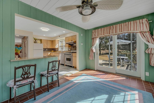 kitchen featuring light tile patterned floors, visible vents, decorative backsplash, a ceiling fan, and stainless steel appliances