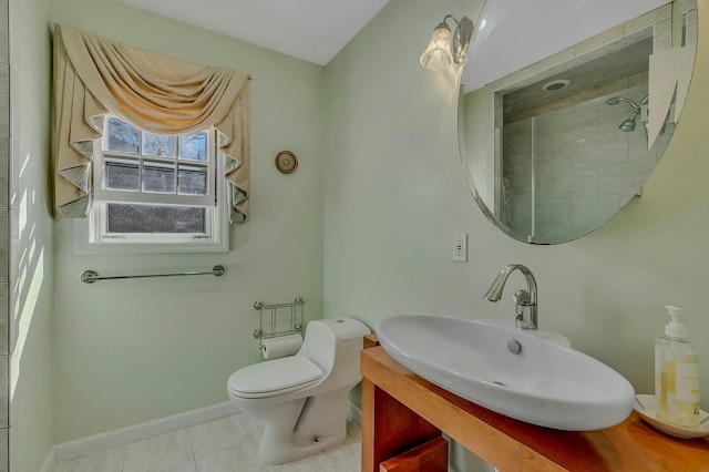 bathroom featuring tile patterned flooring, a sink, toilet, and baseboards