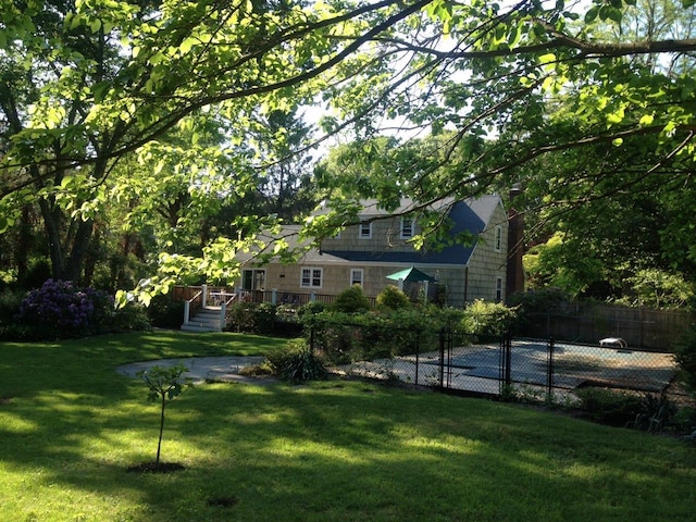 view of yard with fence and a deck