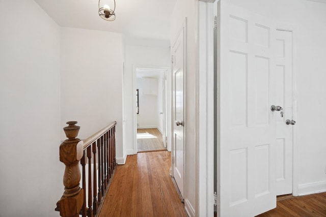 hall featuring baseboards and wood finished floors