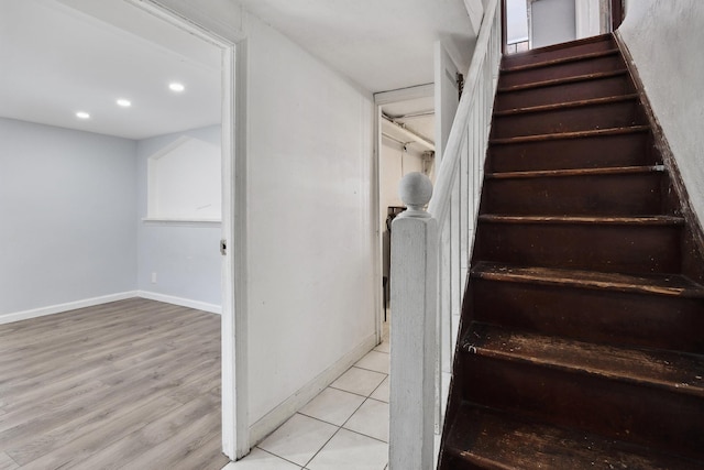 stairway with recessed lighting, wood finished floors, and baseboards