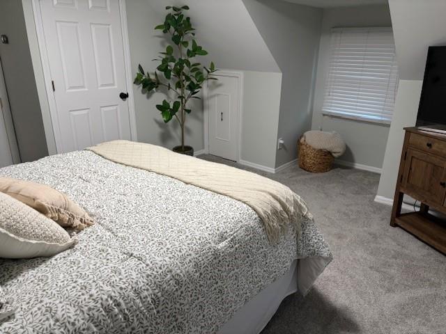 carpeted bedroom featuring baseboards