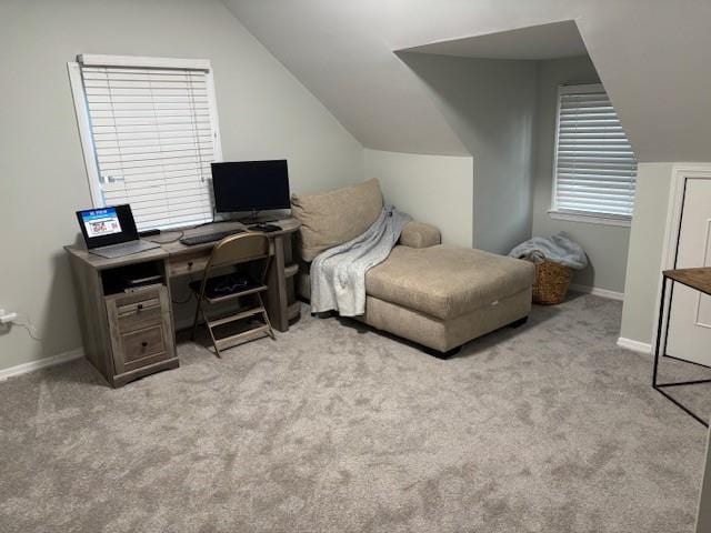 bedroom featuring light colored carpet, vaulted ceiling, and baseboards