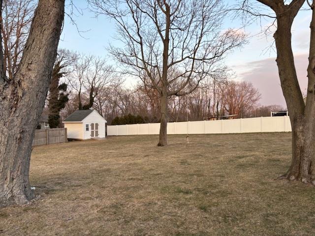 view of yard with an outbuilding and a fenced backyard