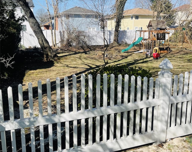 view of yard with a playground and a fenced backyard