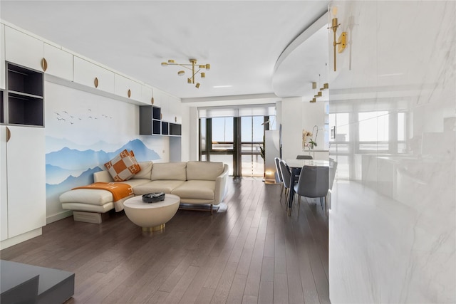 living room with hardwood / wood-style floors and a notable chandelier