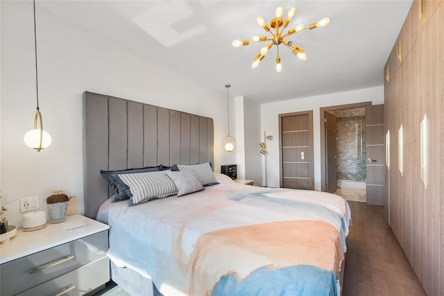 bedroom with hardwood / wood-style flooring and a chandelier