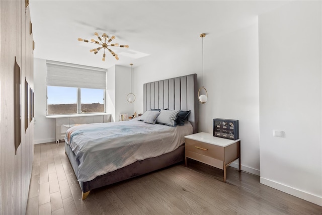 bedroom featuring baseboards and wood finished floors