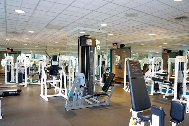 exercise room with visible vents and a drop ceiling