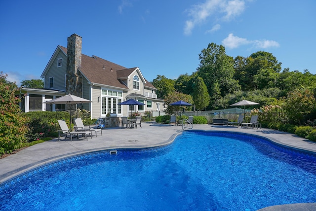 view of swimming pool with a fenced in pool, a patio area, and fence