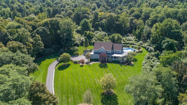 birds eye view of property with a wooded view