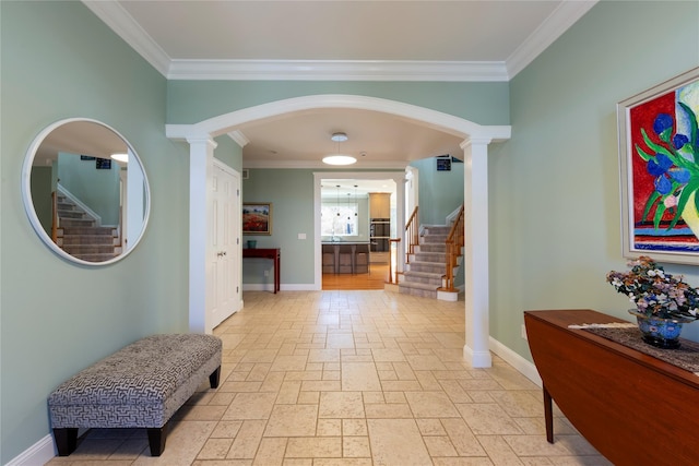 hall featuring decorative columns, stairway, stone tile floors, and baseboards