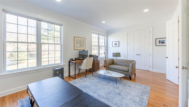 office space with light wood-style flooring, baseboards, crown molding, and recessed lighting