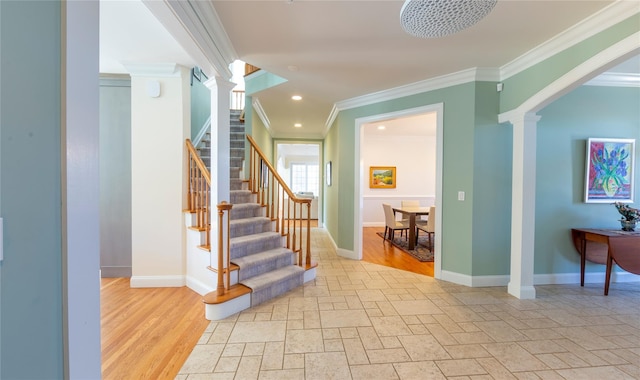 stairway with decorative columns, baseboards, and stone tile floors