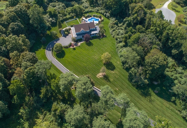 drone / aerial view featuring a forest view