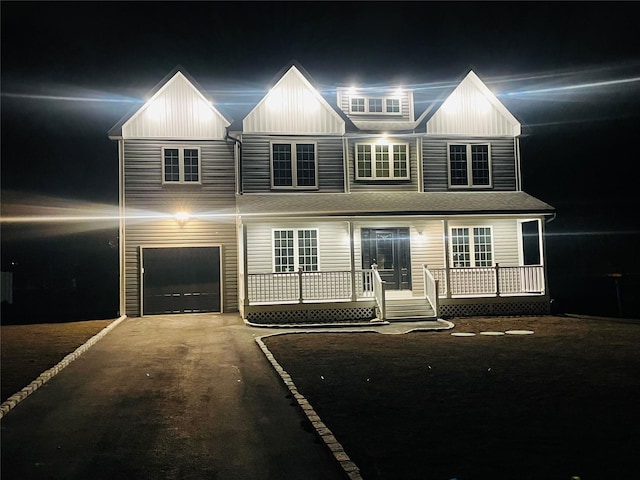 view of front of property with a garage, driveway, and a wooden deck