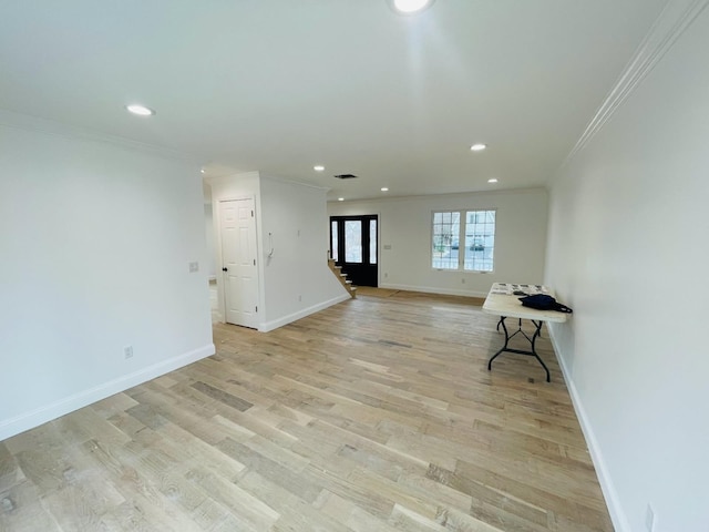 unfurnished room featuring recessed lighting, crown molding, light wood-style flooring, and baseboards