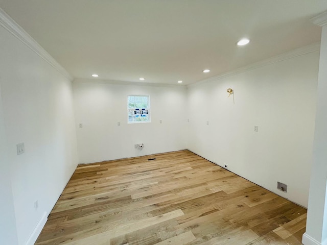 clothes washing area with ornamental molding, light wood-style flooring, and recessed lighting