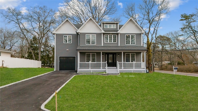 view of front of property with a front lawn, fence, covered porch, a garage, and driveway