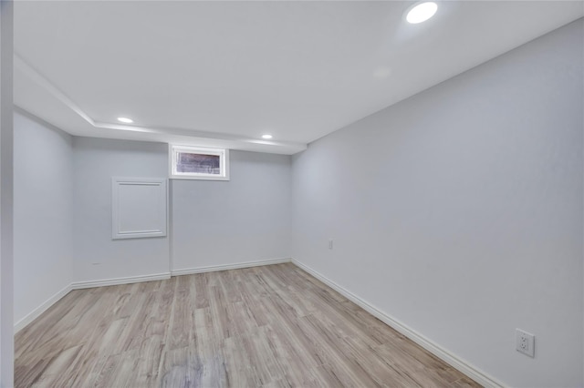 basement featuring recessed lighting, light wood-style flooring, and baseboards