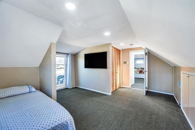 unfurnished bedroom featuring lofted ceiling, carpet flooring, and baseboards